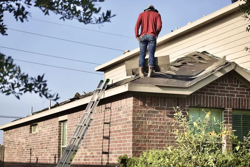 Professional roofer working on a residential roof in North Bloomfield